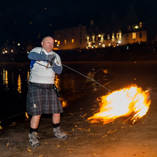 Stonehaven Fireballs Festival Launching Fireball into Harbour